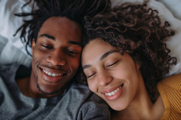 closeup Joyful young couple enjoying a relaxed moment together at home, seated on the bed.
