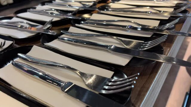 Rotating knife and fork that glitter against black background. High quality 4k footage