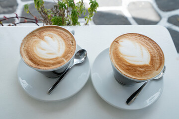 Two cups of coffee on the table, latte art