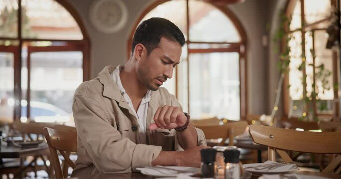 Check time, wait and man in a restaurant, stress and frustrated with reaction and unhappy. Late, nervous and guy in a cafe and coffee shop with a watch and anxious with annoyed feeling and impatient