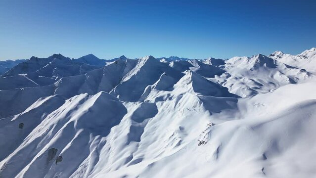 beautiful panoramic view over snow-covered mountains. pan over blue sky and wide horizon