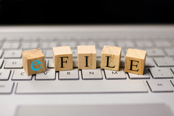 E file text on wooden blocks, Concept of tax filing through e file.