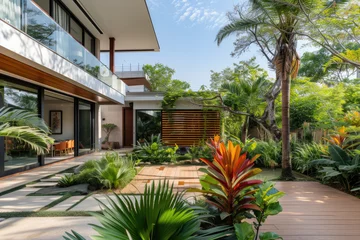 Fotobehang a modern house with many tropical plants and a mini pool © Kien