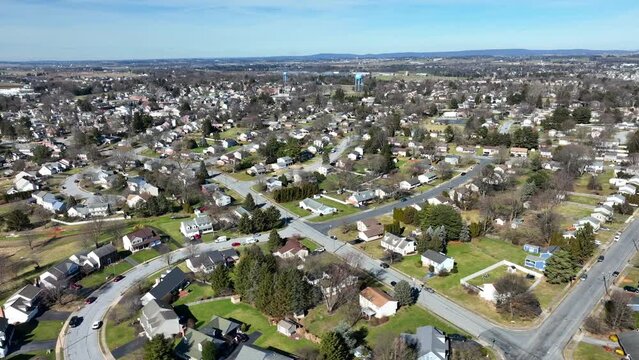 Wonderful neighborhood in scenic landscape at sunlight. American home and property in suburb area of Pennsylvania. Aerial lateral wide shot.