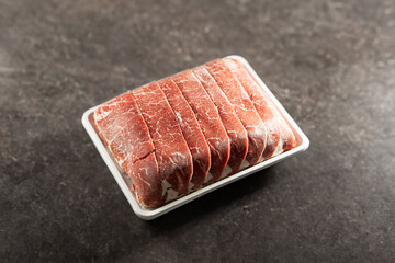 Thinly sliced frozen raw meat