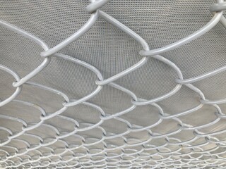 all white steel wire net on a white cement wall in a close-up shot, using as background