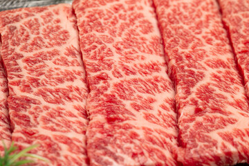 sliced raw meat on plate	