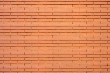 Background from a wall made of orange painted bricks
