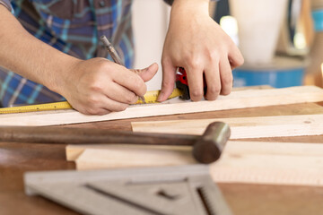 man owner a small furniture business is preparing wood for production. carpenter male is adjust wood to the desired size. architect, designer, Built-in, professional wood, craftsman, workshop.