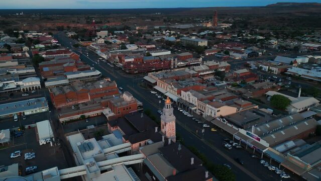 drone shot revealing Kalgoorlie boulder city center with mine shaft in the background, famous Australian mining city, Western Australia