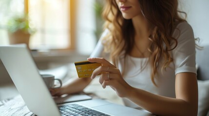 A woman makes shopping online on laptop, paying with a bank plastic credit card. Shopping online, season of sales and discounts. Online store advertising