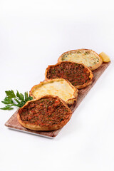 four Pide on a wooden board, on a white background