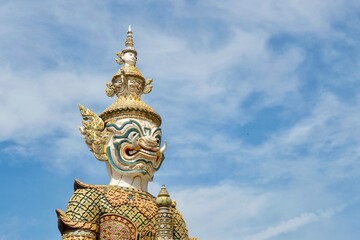 Fototapeta premium Close-up of Sahatsadecha, one of two giant statues - characters from the Ramakien epic - guarding the rear Koei Sadet Gate of the Wat Phra Kaew or Temple of the Emerald Buddha in Bangkok, Thailand 