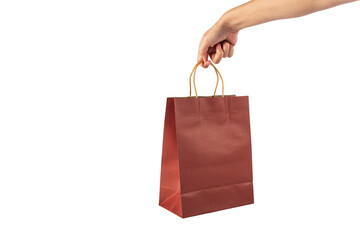 Red paper shopping bag in hand on transparent background.