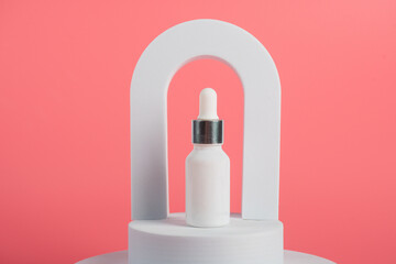 Plastic white tube for cream or lotion. Skin care or sunscreen cosmetic on pink background.