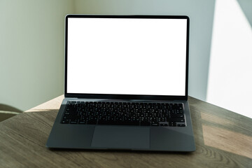 Fototapeta premium Laptop With White Screen on Office Desk blank copy space screen for your advertising text message