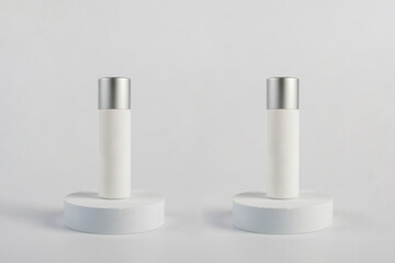 Plastic white tube for cream or lotion. Skin care or sunscreen cosmetic with stylish props on white background 