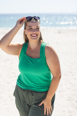 Fototapeta premium Young plus size Caucasian woman enjoys a sunny day at the beach