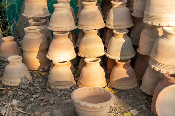 Fototapeta na wymiar New empty clay flowerpot stacked in garden shop