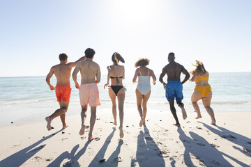 Diverse group of friends enjoy a beach day