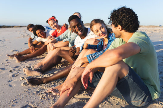 Diverse group of friends enjoy a sunny day at the beach
