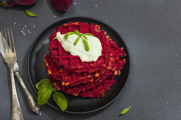 Homemade beetroot Belgian waffles with sauce. Gluten free vegan food with vegetables