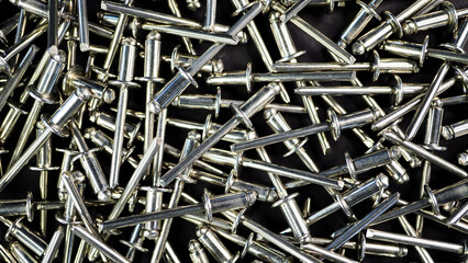 Metal rivets rotate. Close-up. Industrial background.	