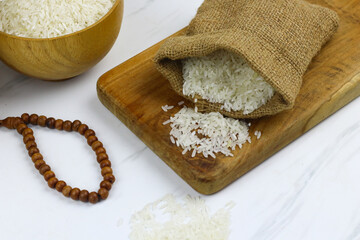 Beras or white rice, Indonesian main food made from Oryza sativa grain. Selective focus, Islamic theme for zakat, ramadan, eid Mubarak background. Copy space for text. 