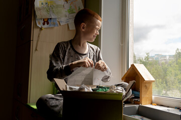 A child tidies up his desk