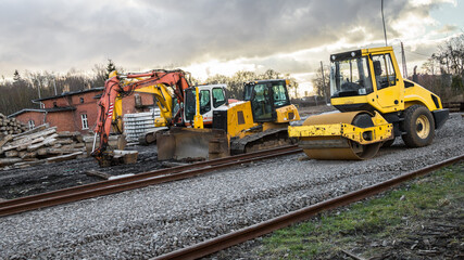 heavy construction equipment ready for work - roller, bulldozer and excavator, diesel engines