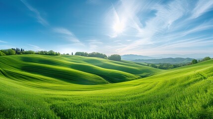 Idyllic Rolling Green Hills Under a Clear Blue Sky with Wispy Clouds.