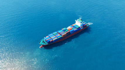 top view Cargo Container ship with contrail in the ocean ship carrying container and running for import export concept technology freight shipping by ship