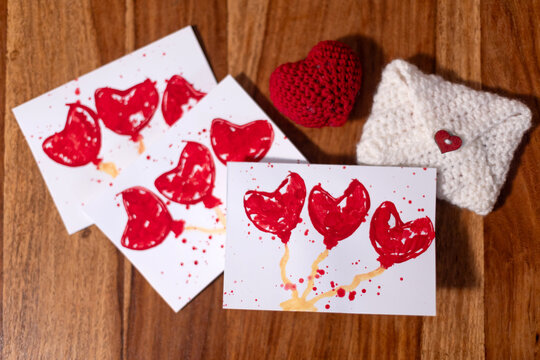Child, making creative art picture with hearts for Valentine