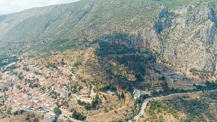 Delphi, Greece. The ruins of the ancient city of Delphi and the modern city. Sunny weather, Summer, Aerial View
