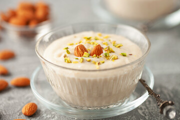 Traditional delicious Turkish Dessert Keskul with nuts in cream bowl