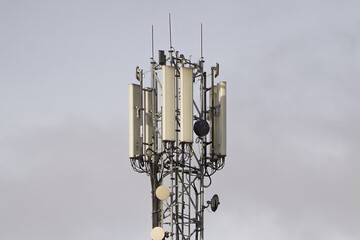 Towering Communication Hub Amidst Cloudy Skies
