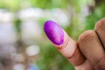 a picture of a man's hand. The ink on a man's finger was obtained after voting during the regional...