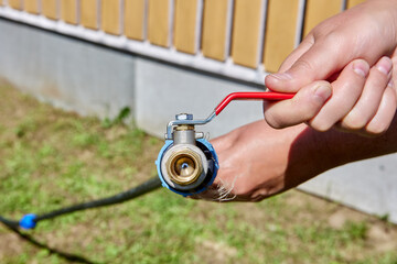 Brass ball valve with an activation lever is connected to polyethylene pipe with compression...