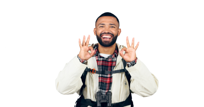 Okay sign, hiking and portrait of man with smile, backpack isolated on transparent png background. Travel, adventure and excited person with vote, review or perfect hand gesture on camping holiday.
