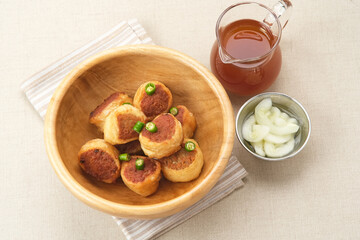 Gohyong or Ngo Hiang, made from minced chicken with flour, served with sour sauce
