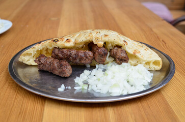 Ćevapi is a traditional bosnian meat dish with cutted onions.