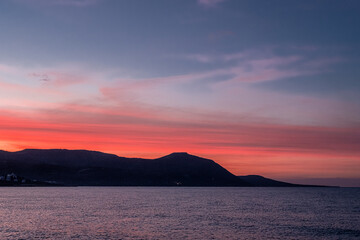 View of the Sunset at Chrysochou Bay as seen from Latsi village harbor, located by the sea, near Neo Chorio village, Akamas Peninsula, Cyprus 