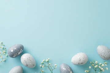 Easter motif display: Overhead image of slate grey eggs, and soft gypsophila, all set against a...
