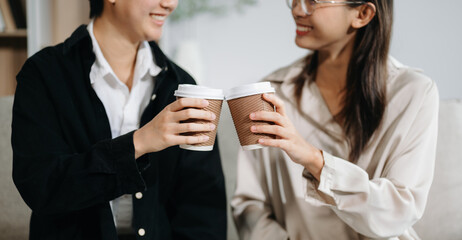 Two business worker standing and holding a coffee cup in modern office, successful, celebration, new project, team office .