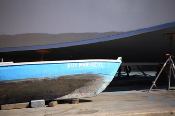 front part of a blue rowing boat on land