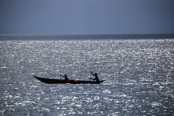 Fototapeta premium silhouette of two fishermen in a dugout