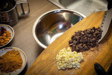 Woman cooking tasty melted chocolate on table in kitchen.