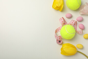Tennis ball with flowers on a light background.