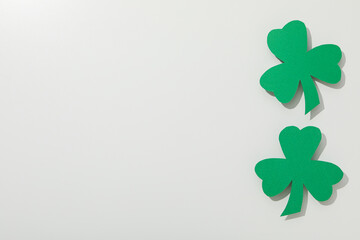 Green paper clover leaves on white background, space for text