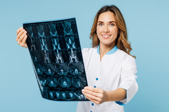 Female fun doctor woman wears white medical gown suit work in hospital clinic office hold x-ray brain by radiographic image ct scan mri isolated on plain blue background. Health care medicine concept.